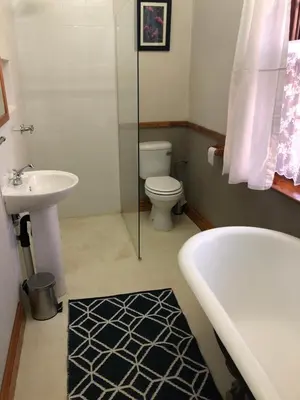 a bathroom with a tub and a toilet and a sink at Apple and Rose in Belfast