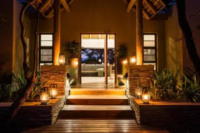 a house with a hallway with lights and a door at Moya Safari Villa in Hoedspruit