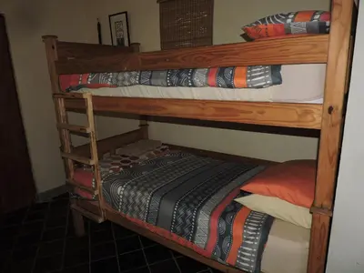 a couple of bunk beds in a room at Kruger Inn Backpackers in Marloth Park