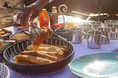 a table with a bowl of food on a table at Tomo Safari Lodge in Hoedspruit