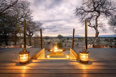 a fire pit with lights on a wooden deck at Tomo Safari Lodge in Hoedspruit