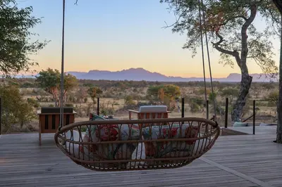 a basket filled with flowers sitting on a porch at Tomo Safari Lodge in Hoedspruit
