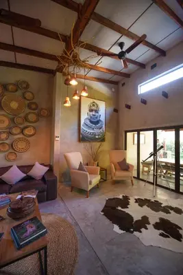 a living room with a couch and a table at Dream of Africa Bush Lodge in Marloth Park