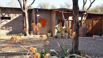 a house with a painting on the side of it at Dream of Africa Bush Lodge in Marloth Park