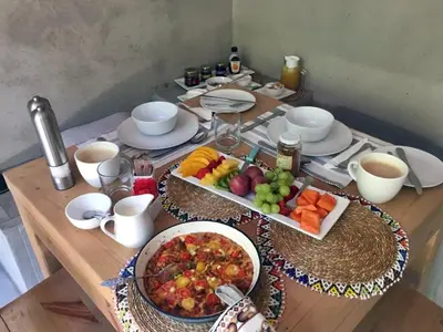a wooden table with a tray of fruit on it at Dream of Africa Bush Lodge in Marloth Park