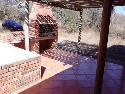 an outside view of a brick building with a grill at Eagle's Crest in Marloth Park