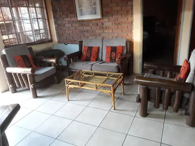 a living room with chairs and a coffee table at Eagle's Crest in Marloth Park