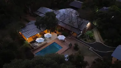 an overhead view of a house with a swimming pool at Rocky Hollow Lodge in Pretoria