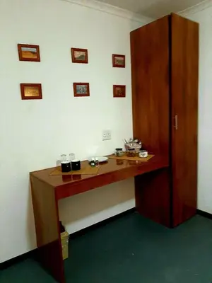 a wooden desk in the corner of a room at Rocky Hollow Lodge in Pretoria