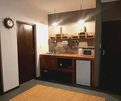 a kitchen with a counter and a sink and a clock at Rocky Hollow Lodge in Pretoria