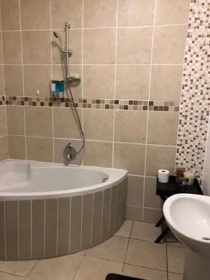 a bathroom with a tub and a sink at Sweet Home Alibama in Nelspruit