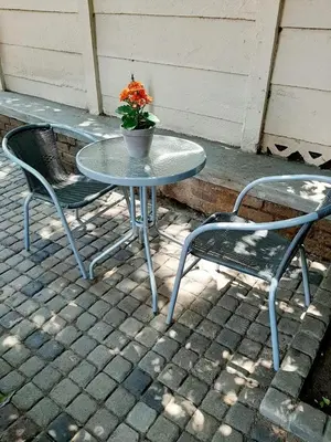 two chairs and a table with a potted plant on it at Sweet Home Alibama in Nelspruit