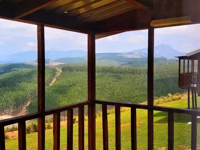a view of the mountains from a screened in porch at Forest View Cabins in Tzaneen