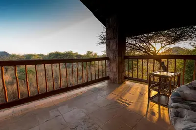 a room with a balcony with a table and a chair at Makhato Bush Lodge 111 in Bela-Bela