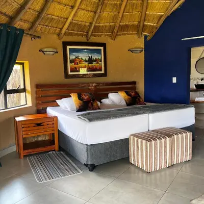 a bedroom with a large bed in a room at Mountain Aloe Den in Barberton