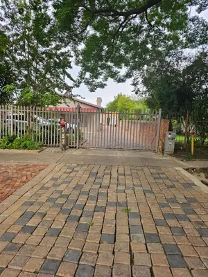 a brick driveway with a fence and a gate at LPM Guests at 21st in Pretoria