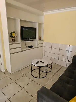 a living room with a couch and a tv at LPM Guests at 21st in Pretoria