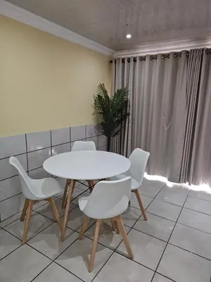 a white table and chairs in a room at LPM Guests at 21st in Pretoria