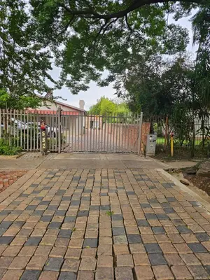 a driveway with a gate and a fence at LPM Guests at 21st in Pretoria
