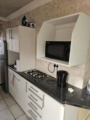 a kitchen with a microwave and a stove top oven at LPM Guests at 21st in Pretoria