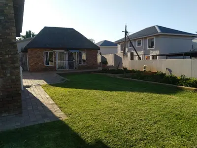 a yard with a house and a fence at LPM Guests at 21st in Pretoria