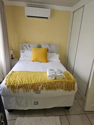 a bedroom with a bed with two towels on it at LPM Guests at 21st in Pretoria