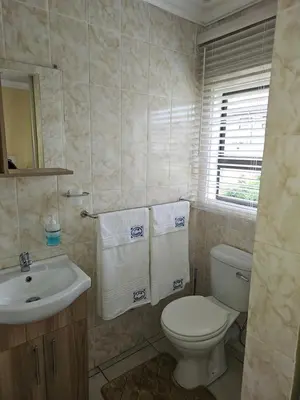 a bathroom with a white toilet and a sink at LPM Guests at 21st in Pretoria
