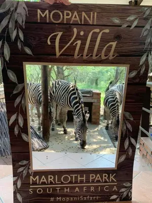 a sign with two zebras at a marriott park at Mopani Villa in Marloth Park