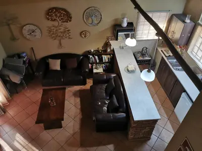 an overhead view of a living room with a counter and chairs at Mopani Villa in Marloth Park