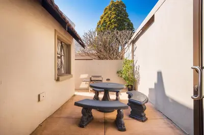 a patio with two tables and two stools at Ginger Barn Retreat - 1km from Menlyn in Pretoria