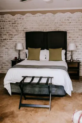 a bedroom with a large bed with a black headboard at La Bendicion in Witbank
