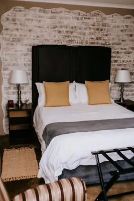a large bed with a black headboard in a bedroom at La Bendicion in Witbank