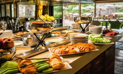 a buffet line with different types of bread and vegetables at Sabi River Sun Resort in Hazyview