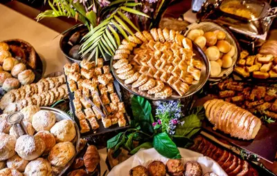a table full of different types of bread and pastries at Sabi River Sun Resort in Hazyview