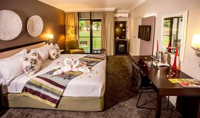 a bedroom with a bed with two babies laying on it at Sabi River Sun Resort in Hazyview
