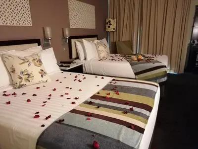 a hotel room with two beds with roses on the sheets at Sabi River Sun Resort in Hazyview