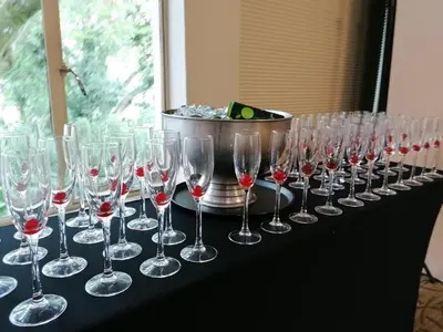 a row of wine glasses sitting on a table at Sabi River Sun Resort in Hazyview