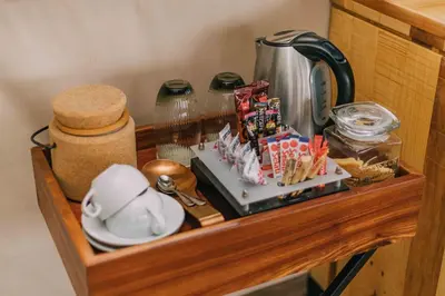 a shelf in a kitchen with a tea pot and food at Mdluli Safari Lodge in Hazyview