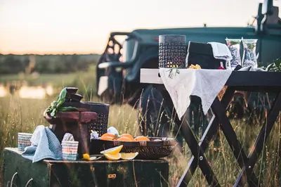 a picnic table with baskets of fruit on a field at Mdluli Safari Lodge in Hazyview