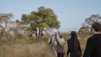 a group of people standing in a field at Mdluli Safari Lodge in Hazyview