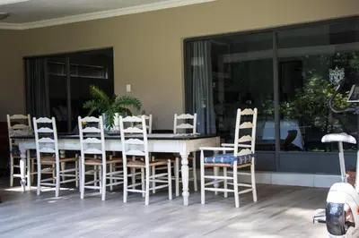 a dining room with a table and chairs at 64 on Malabor in Pretoria