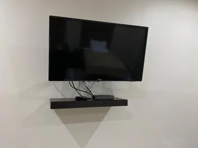 a flat screen tv sitting on a wall at Aqua Stone guest house in Nelspruit