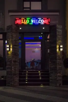 a welcome sign in front of a hotel at night at Aqua Stone guest house in Nelspruit