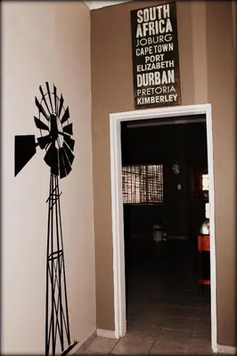 a windmill in the corner of a room with a sign at Aqua Terra Guest House in Lydenburg