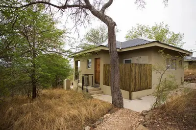 a small house with a wooden fence in a yard at isiLimela Game Lodge in Hoedspruit