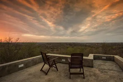 two chairs sitting on a ledge with a view at isiLimela Game Lodge in Hoedspruit