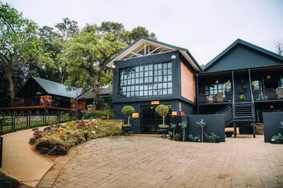 a large black house with a courtyard at The Bohemian Guesthouse in Tzaneen