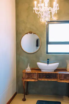 a bathroom with a sink and a mirror at The Bohemian Guesthouse in Tzaneen