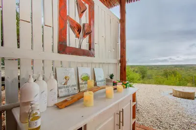a room with a counter with bottles and candles at Casart Game Lodge in Grietjie Nature Reserve
