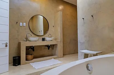 a bathroom with two sinks and a tub and a mirror at Kings Walden Garden Manor in Tzaneen
